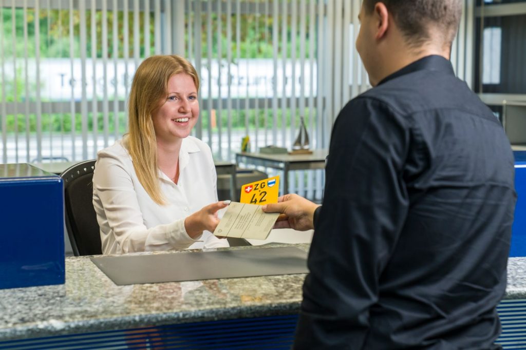 An employee of the Road Traffic Office Zug serves international customer: The English language and cultural understanding have become increasingly important.