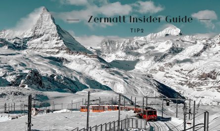 Red train on Gornergrat railway in front of the Matterhorn Mountain in Zermatt, Switzerland surrounded by blue skies and clouds