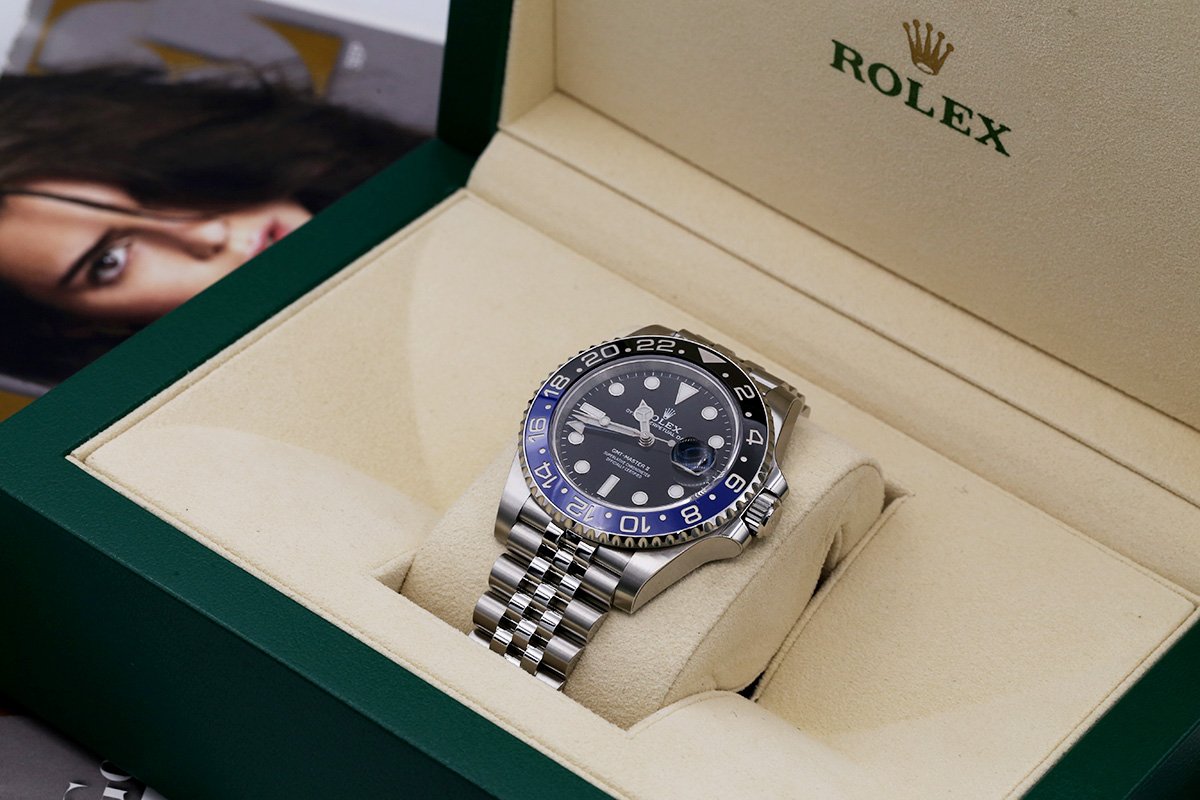 A Rolex BLRN batman shown in the box being presented to the buyer