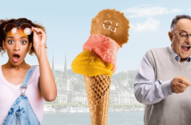 junge, erstaunte Frau mit Gelato Cornet in der Hand und älterer Herr mit Brille mit Gelato-Becher in der Hand auf dem Hintergrund der Stadt Luzern