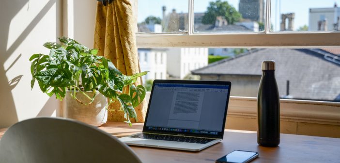 A home office set up in front of a window