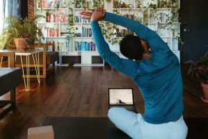 Person stretching in front of Laptop