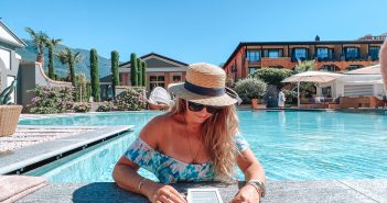Woman in the pool reading a book at Hotel Giardino Ascona