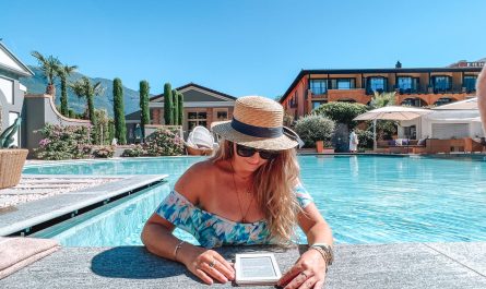 Woman in the pool reading a book at Hotel Giardino Ascona