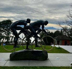 Cyclist statue at the Olympic Museum in Lausanne with the lake in the background.