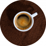 Cup of coffee on ground coffee.